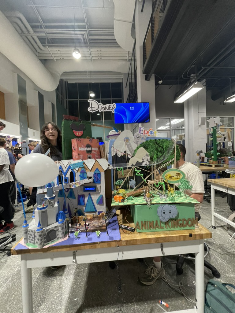The full Disney World-themed Rube Goldberg machine on a lab workbench